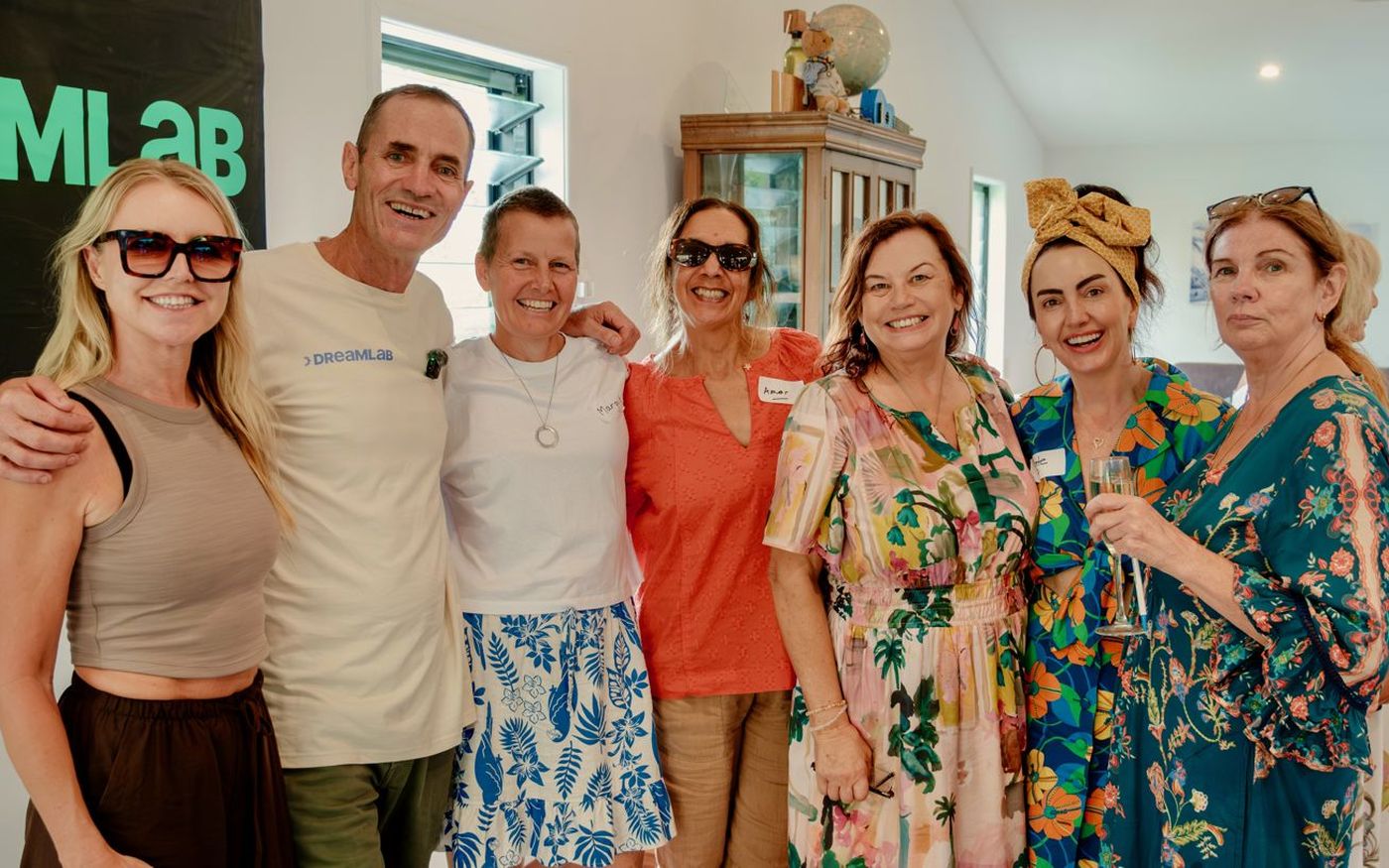 Mike with a group of smiling women at a Dream Lab event
